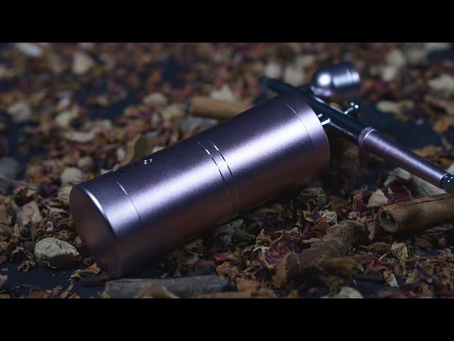 Close-up of professionally airbrushed nails with gradient ombre design and metallic accents